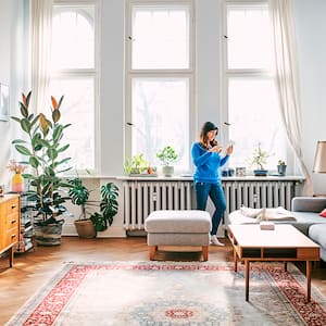 woman hanging out in her house by radiator 